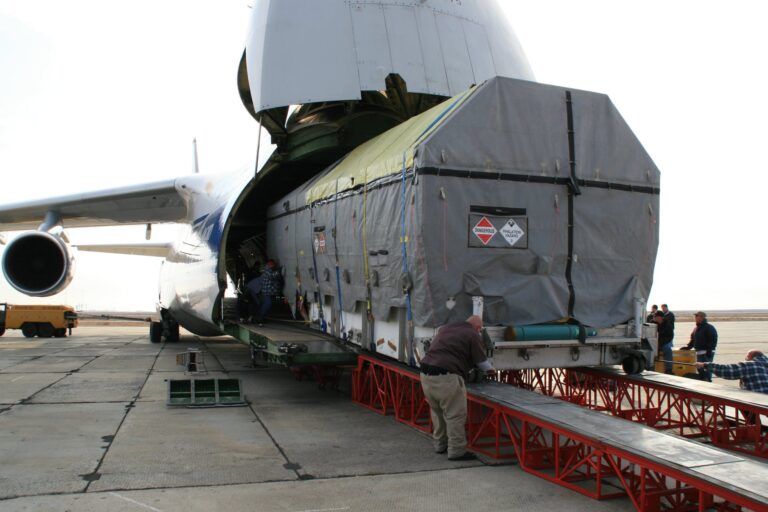 A large piece of cargo is being loaded on a cargo plane.