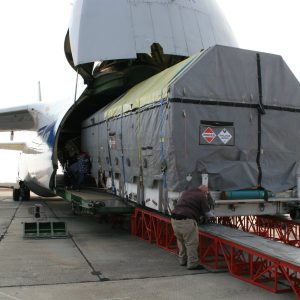 A large piece of cargo is being loaded on a cargo plane.
